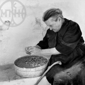 Old woman preparing the mirmitzeli, Dryos, Paros 1972.